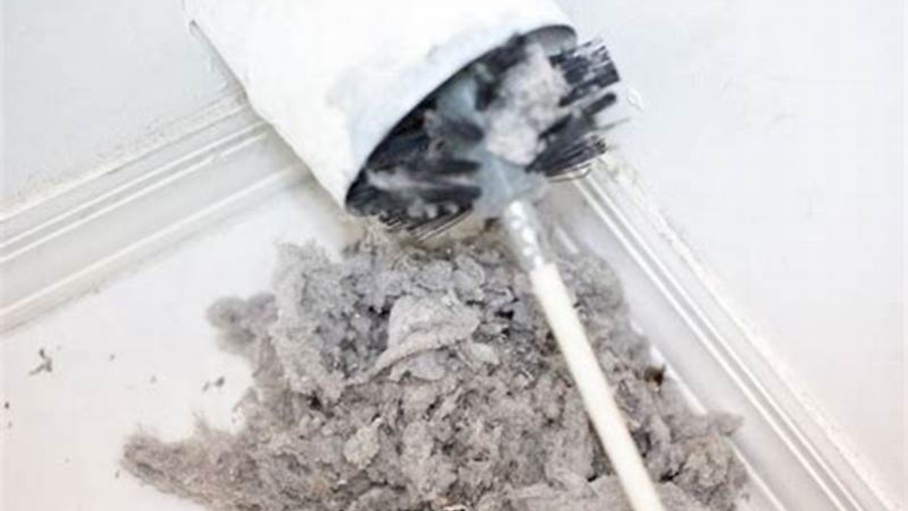 Dryer vent brush removing lint buildup from vent pipe